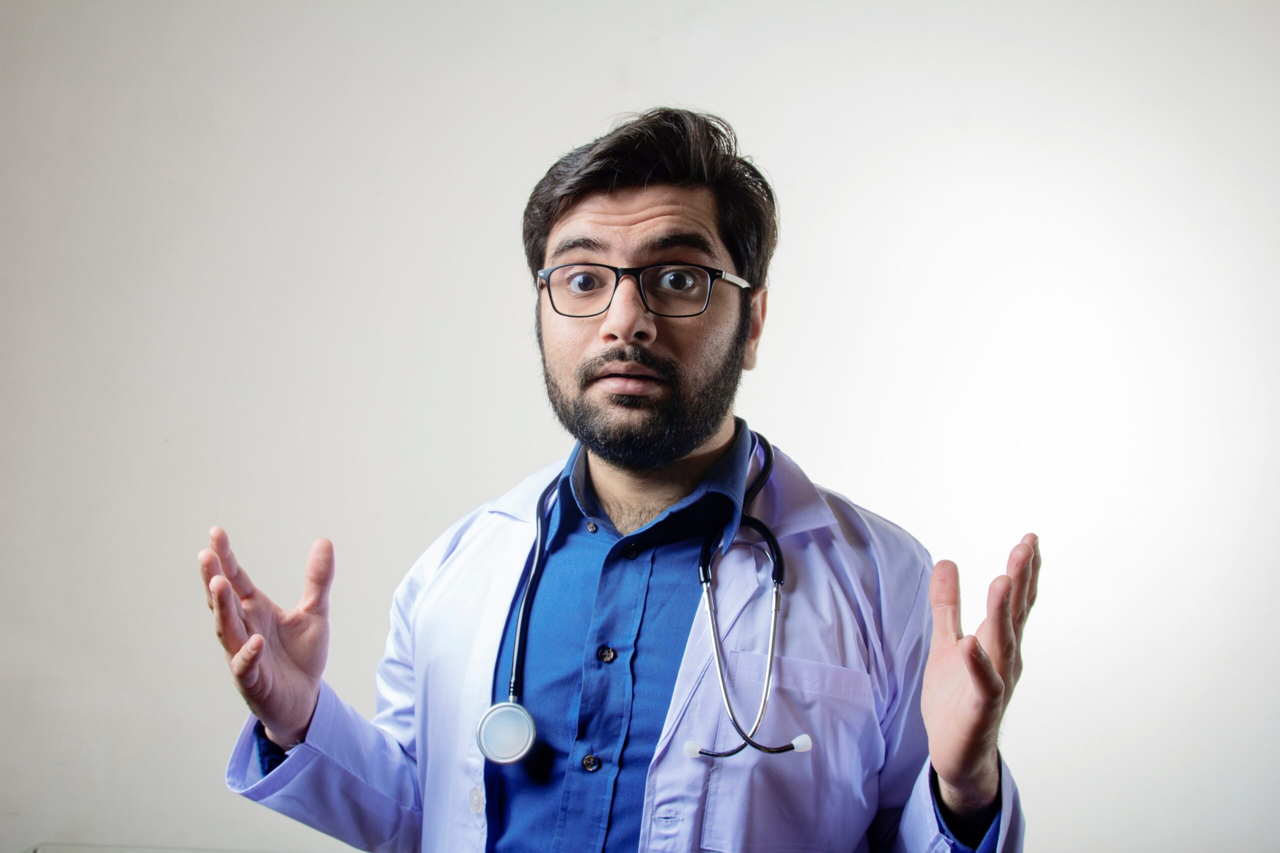 A doctor pointing forwards with expressions