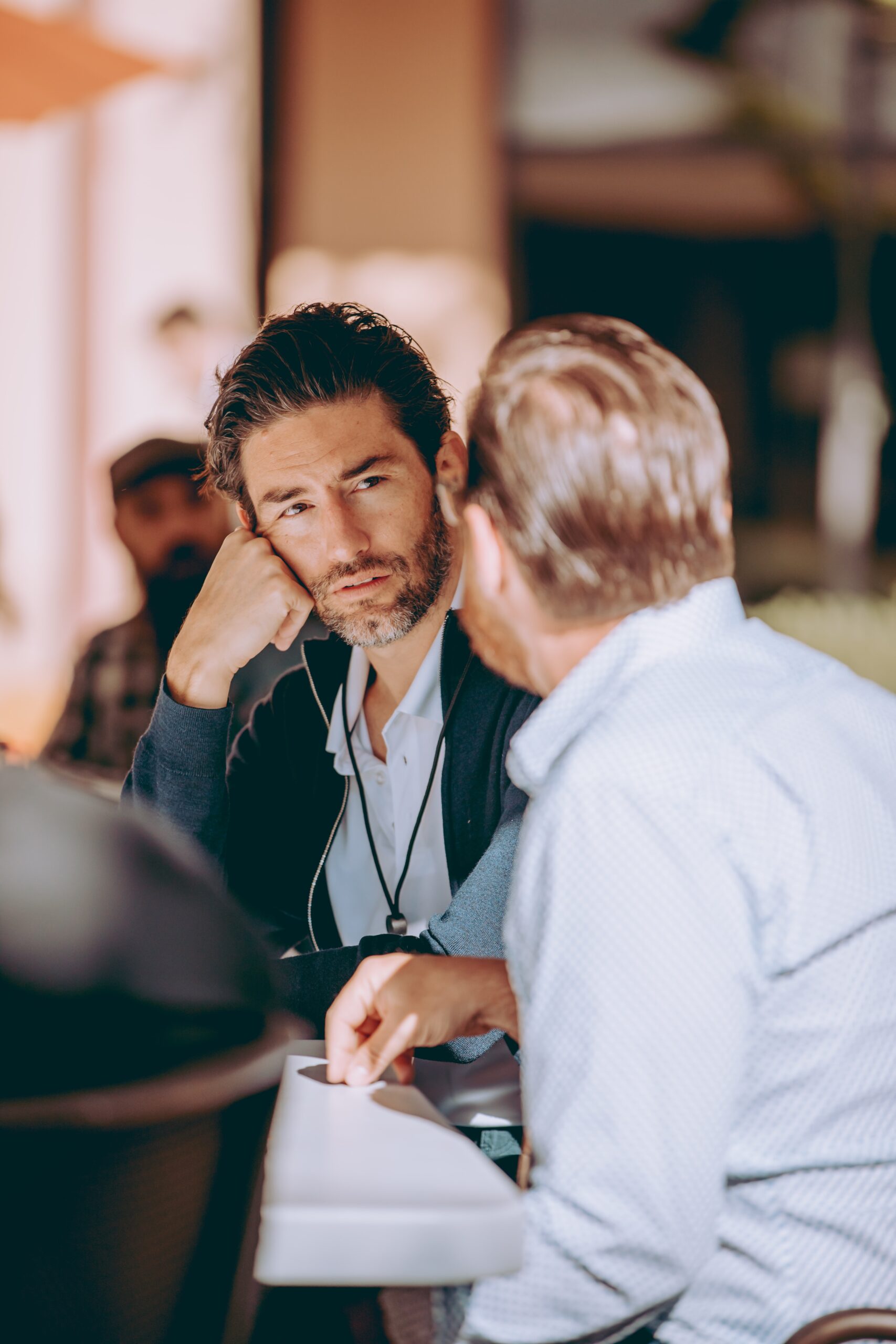 Two men having a conversation at a business conference at Stanford University